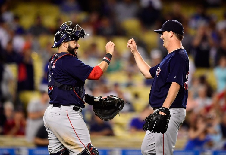 Boston Red Sox catcher Sandy Leon, left, congratulates starting pitcher Steven Wright after the Red Sox defeated the Los Angeles Dodgers 9-0 Friday. Associated Press/Mark J. Terrill