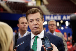 Trump campaign chairman Paul Manafort talks to reporters on the floor of the Republican National Convention in July. New revelations raise questions about Manafort's business practices before he joined the Trump campaign.