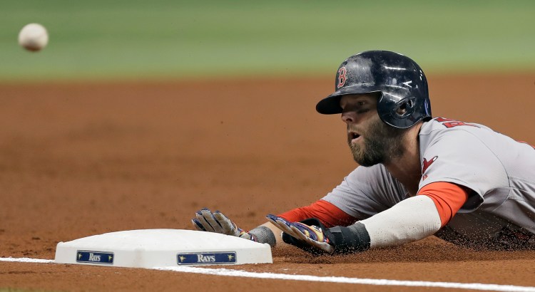 Dustin Pedroia slides into third base ahead of the throw to Tampa Bay's Evan Longoria on Tuesday. Pedroia advanced from second base on a flyout by David Ortiz.    Associated Press/Chris O'Meara