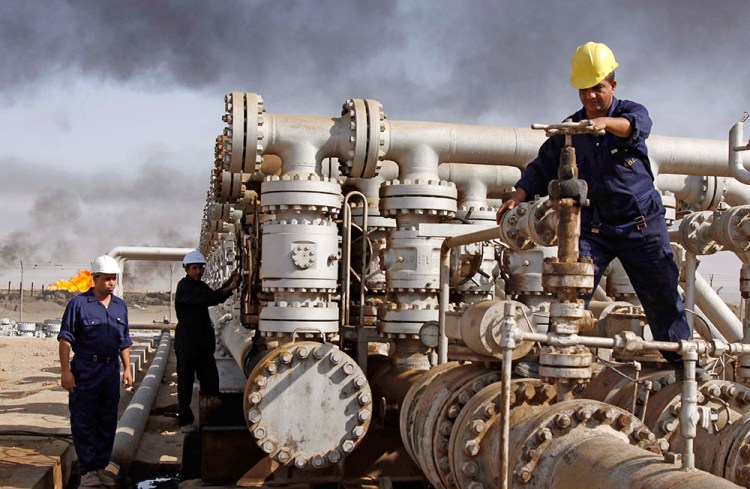 Iraqi workers maintain valves at the Rumaila oil refinery, near Basra, about 340 miles southeast of Baghdad. Donald Trump has said he would have used money from the sale of Iraqi oil to pay for the care of wounded soldiers and the families of those Americans killed in the war. 2009 photo by Nabil al-Jurani/Associated Press