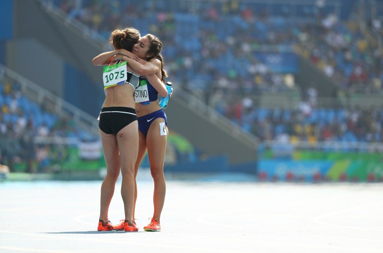 Nikki Hamblin of New Zealand and Abbey D'Agostino of the United States embrace after a grueling 5,000-meter run preliminary Tuesday.   Reuters/Lucy Nicholson