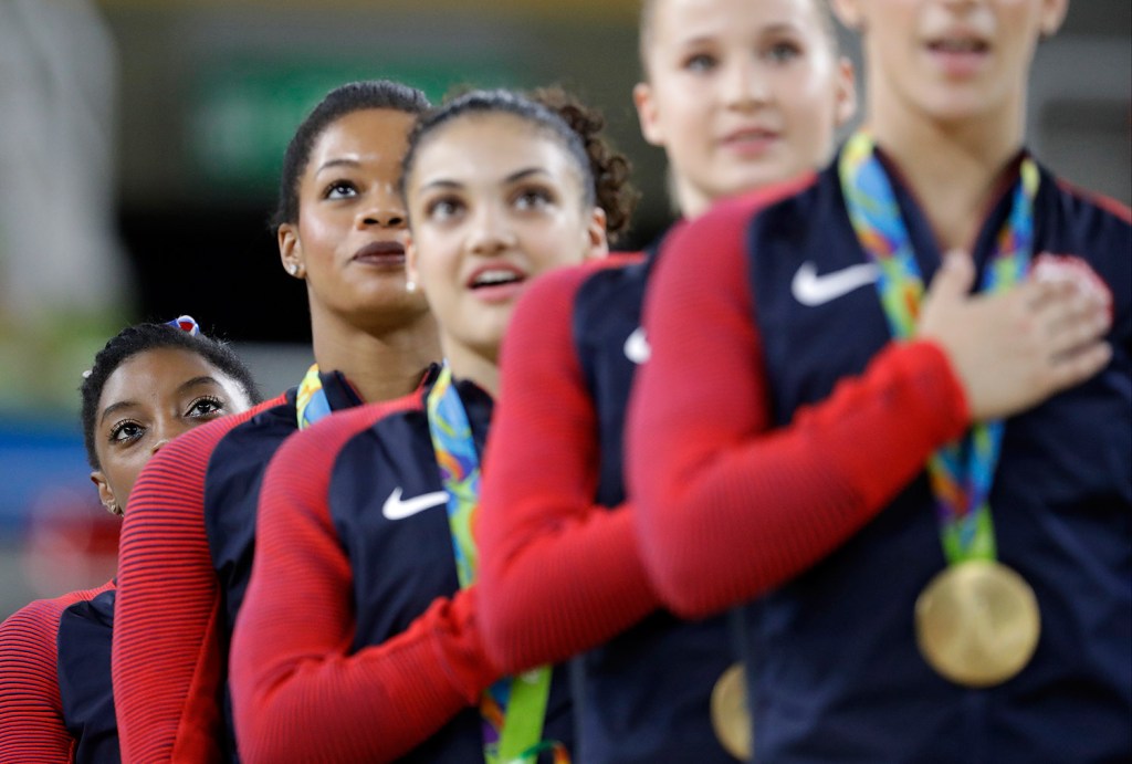U.S. gymnasts, left to right, Simone Biles, Gabrielle Douglas, Lauren Hernandez, Madison Kocian and Aly Raisman stand for their national anthem Tuesday during the medal ceremony for the artistic gymnastics women's team competition.
Associated Press/Julio Cortez