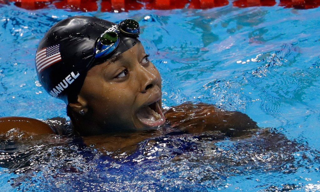 Simone Manuel of the U.S. celebrates winning a gold medal and setting a new Olympic record in the women's 100-meter freestyle Thursday night. Associated Press/Natacha Pisarenko