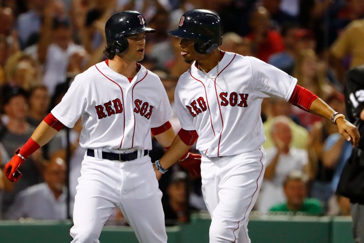 Boston's Andrew Benintendi, left, went 3-for-3 Tuesday night and scored two runs in a 5-3 win over the Yankees.    Associated Press/Winslow Townson