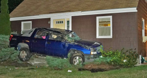 Shane McAlister is accused of crashing this SUV into a house in Yarmouth after a police chase on Aug. 26. He then fled. Contributed photo by Tom Bell