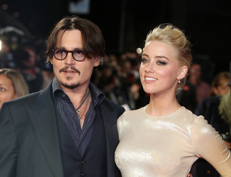 Amber Heard announced Tuesday she would donate proceeds from her divorce to Johnny Depp as she agreed to drop an abuse charge.    Associated Press/Joel Ryan