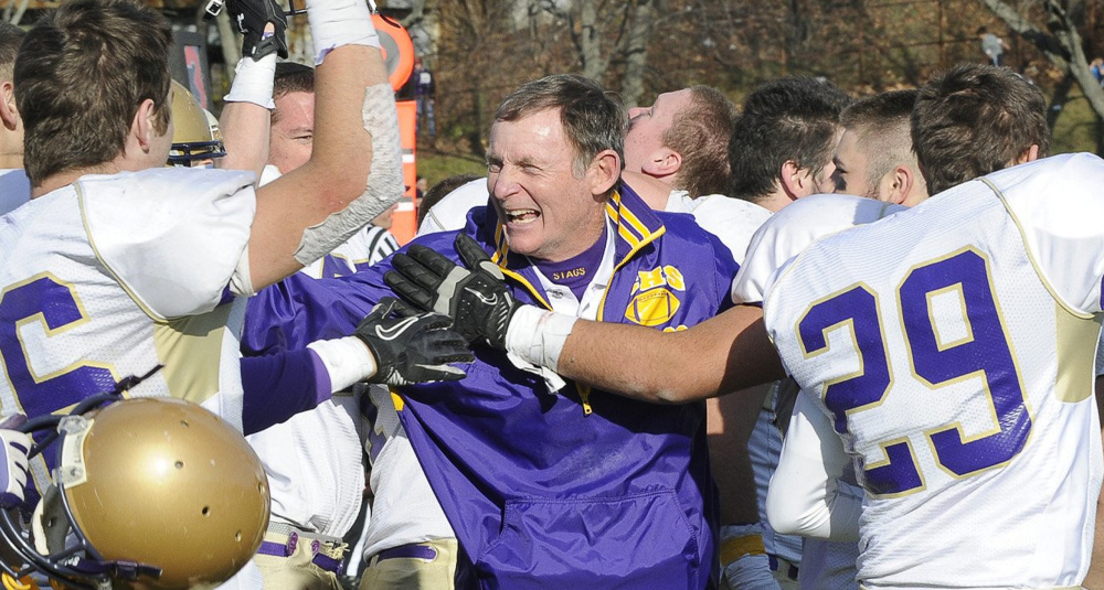 John Wolfgram's football teams won 10 state titles in 40 years, his final two with Cheverus, including this celebration with his players after defeating Lawrence 49-7 in 2011.