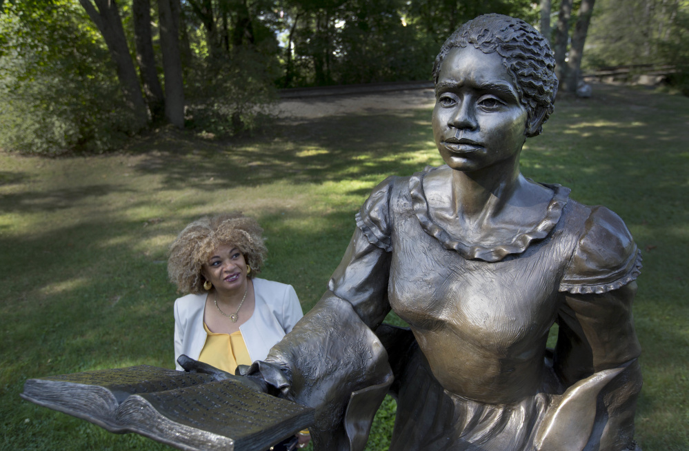 JerriAnne Boggis stands next to a statue of Harriet Wilson in Milford, N.H. Boggis is part of a group of scholars working on what they hope will be a statewide, black history trail.