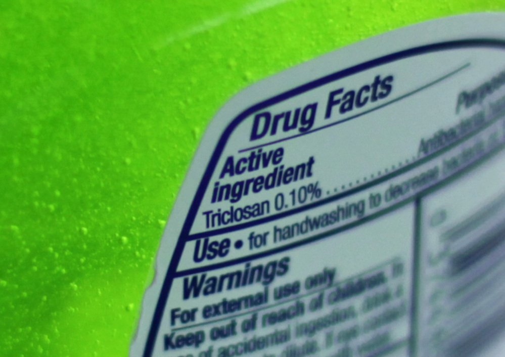 This Tuesday, April 30, 2013 file photo shows the label of a bottle of antibacterial soap in a kitchen in Chicago. The U.S. government is banning more than a dozen chemicals, including triclosan, long-used in antibacterial soaps and washes, saying manufacturers have failed to show that they are safe and prevent the spread of germs.