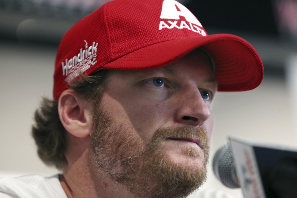 Dale Earnhardt Jr., shown on Aug. 5 addressing the media, will miss the rest of the NASCAR season as he continues to recover from a concussion.