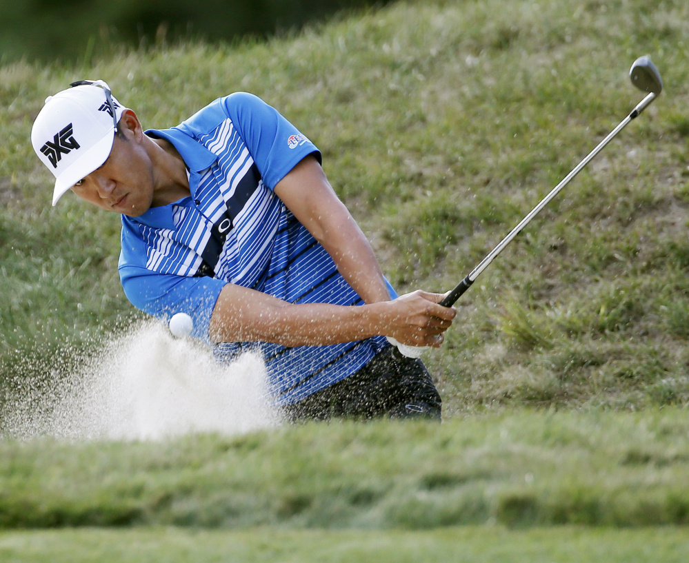 Co-leader James Hahn hits from a bunker to the eighth green during the first round of the Deutsche Bank Championship on Friday in Norton, Mass.