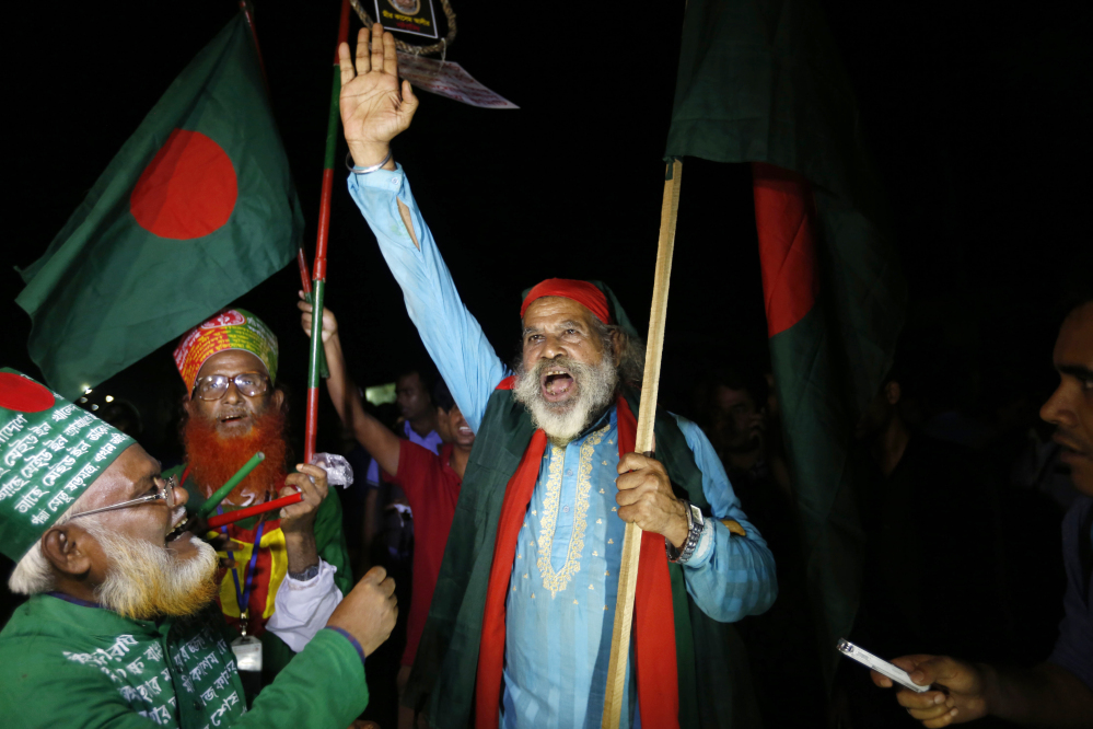 An activist celebrates near the Kashimpur Central Jail after the execution of Mir Quasem Ali.