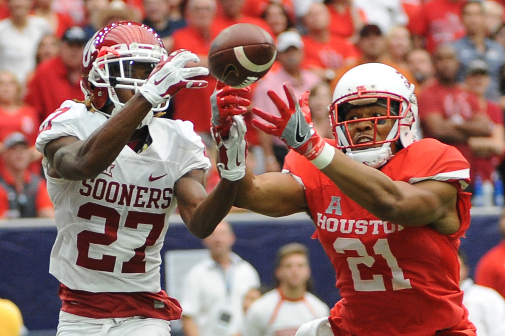 Oklahoma cornerback Dakota Austin, left, and Houston wide receiver Chance Allen reach for a pass that fell incomplete in the second half of Houston's 33-23 victory at home Saturday.