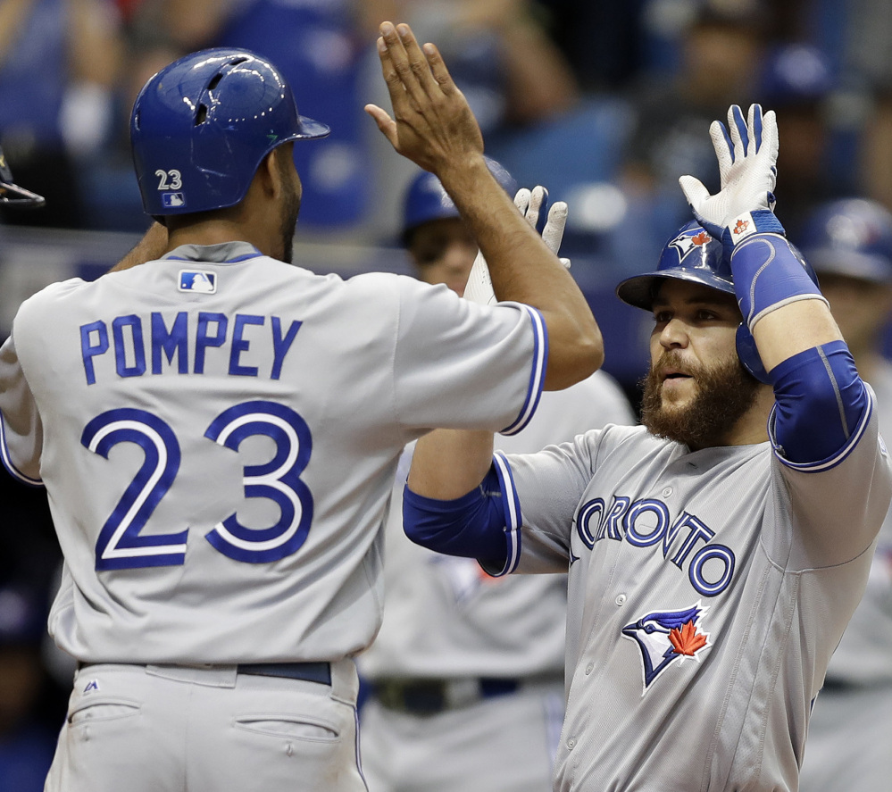 Toronto's Russell Martin celebrates with Dalton Pompey after hitting a two-run homer during a 5-3 win over the Rays at St. Petersburg on Sunday.