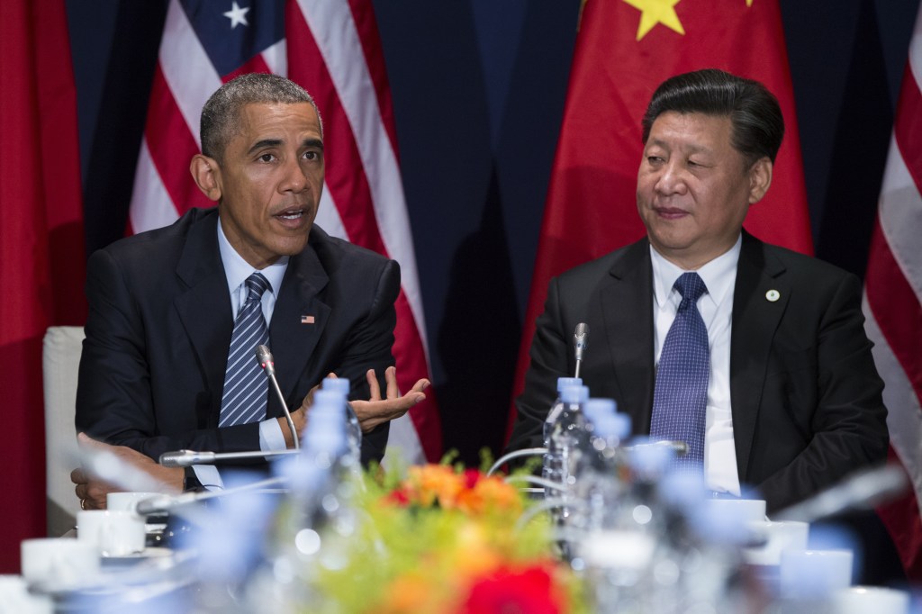 In this photo taken Nov. 30, 2015, President Barack Obama meets with Chinese President Xi Jinping in Le Bourget, France.  A trade deal that is a centerpiece of Obama's efforts to counter Chinese influence in Asia hangs in the balance as he makes his last visit to Asia as president.  (AP Photo/Evan Vucci)
