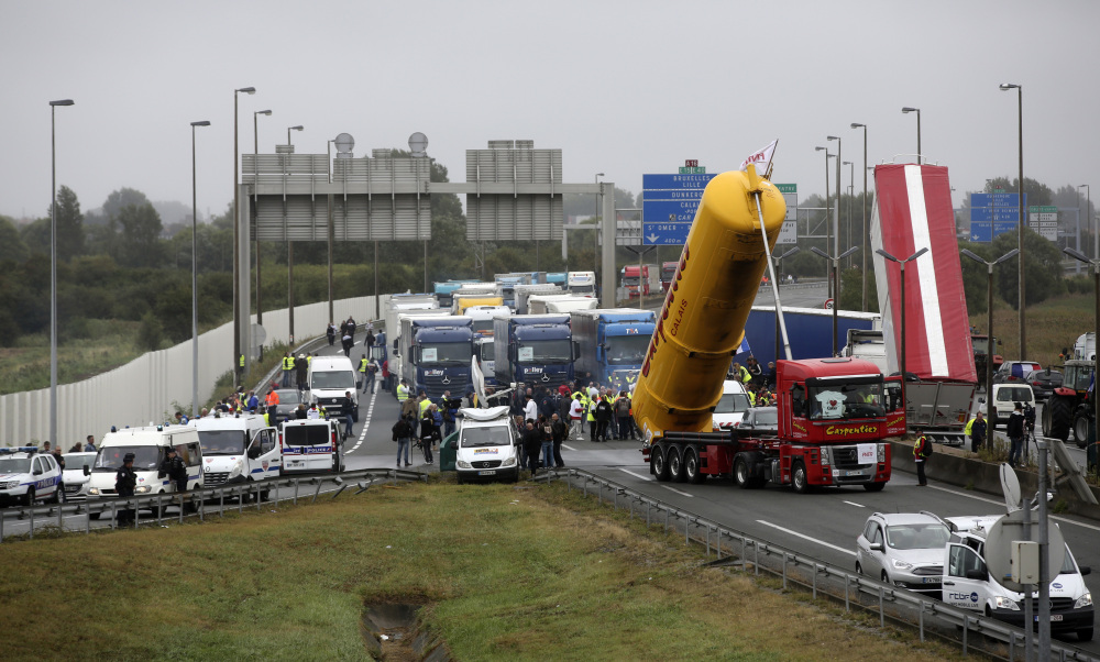 Truckers and other protesters block the highway near Calais, France, on Monday to demand the closure of a migrant camp. The blockade ended after protesters were assured the camp would be dismantled "in a single step," though a date was not offered.
