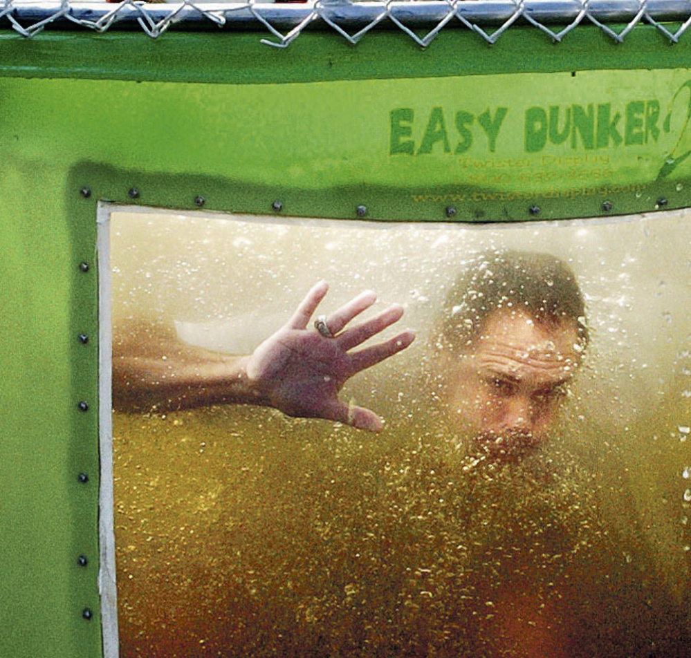 State Rep. Brad Farrin looks out from a dunk tank after volunteering for the Norridgewock Fire Department's fundraiser during Oosoola Days festivities on Monday.
