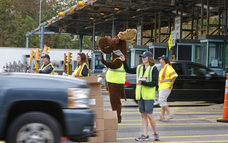 Drivers going south on the Maine Turnpike on Monday morning are greeted at the York toll plaza by Miles the Moose and Clawdette the Lobster, along with turnpike authority employees who handed out copies of the 2017 Farmers' Almanac.
Jill Brady/Staff Photographer