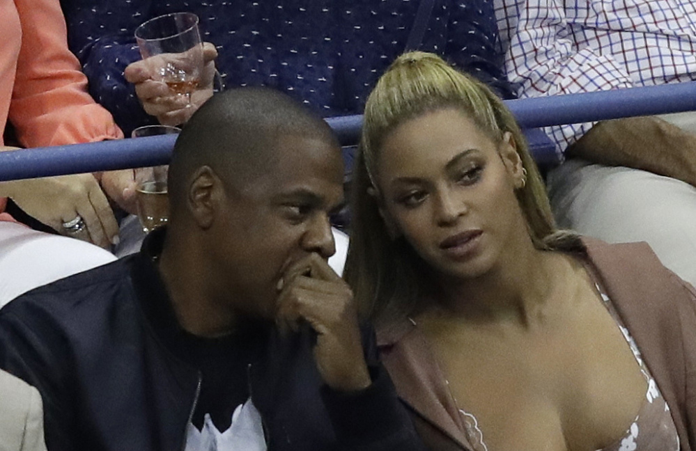 Jay-Z and Beyoncé talk while watching Serena Williams play Vania King at the U.S. Open in New York City last week.