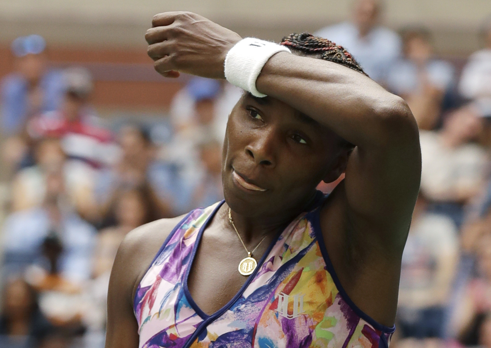 Venus Williams wipes sweat from her brow between serves to Karolina Pliskova of the Czech Republic during the fourth round of the U.S. Open on Monday.