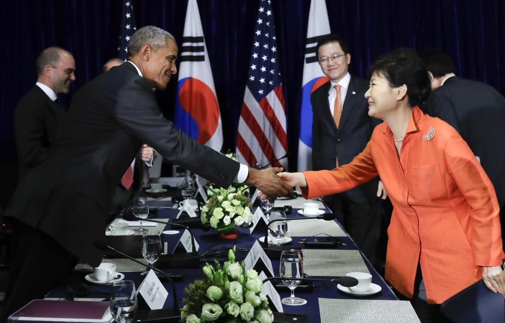President Obama, left, and South Korean President Park Geun-hye shake hands after speaking to the media at the conclusion of a bilateral meeting in Vientiane, Laos.