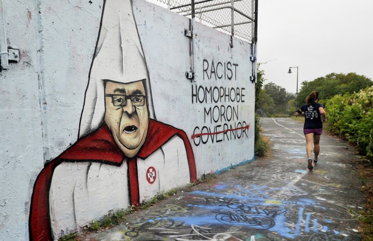 The 100-foot-long wall at the East End wastewater treatment plant in Portland has long been designated as a space for public art. But Mayor Ethan Strimling said he wanted the latest work – a scathing depiction of Gov. Paul LePage dressed in Ku Klux Klan regalia – removed. That wish was fulfilled late Tuesday, when the mural looked much different, A5.
