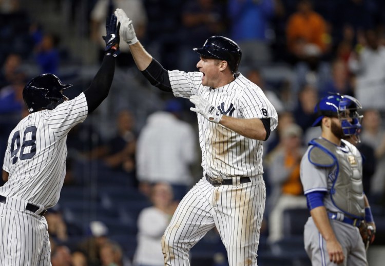 Chase Headley of the New York Yankees celebrates his two-run homer with Eric Young Jr. during the eighth inning of a 7-6 win by the Yankees at New York on Tuesday.