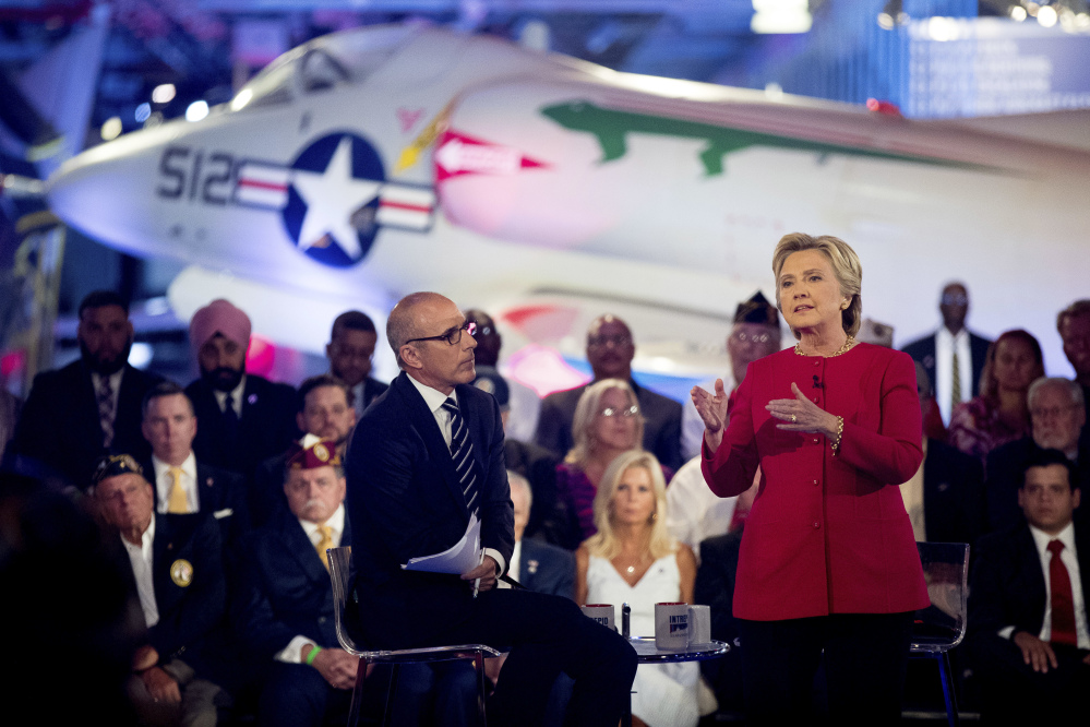 Hillary Clinton, with "Today" show co-anchor Matt Lauer, speaks at the forum on national security Wednesday night at the Intrepid Sea, Air and Space museum in New York. She urged voters to weigh her readiness to be president based on "the totality of my record."