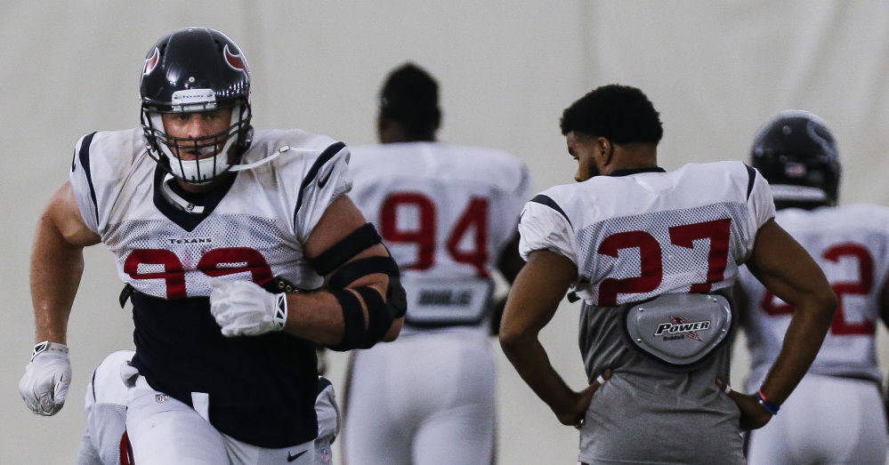 Texans defensive end J.J. Watt, left,  practices with the team in Houston on Monday. Watt was finally back on the practice field after offseason back surgery and is expected to play Sunday at home against the Bears.