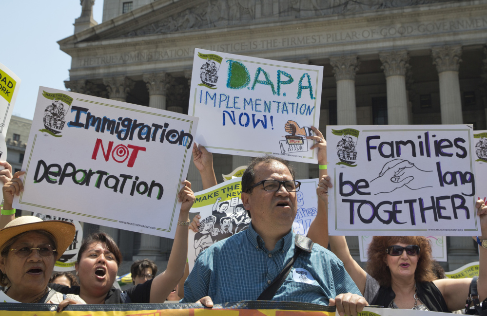 Demonstrators gather outside the New York Supreme Court in June to protest against a U.S. Supreme Court decision on immigration.