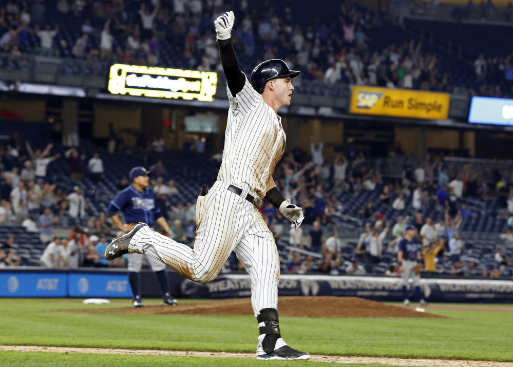 Yankees rookie Tyler Austin celebrates his game-ending home run off Rays reliever Erasmo Ramirez in the ninth inning Thursday night. The homer gave the Yankees a 5-4 win.