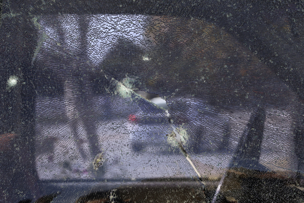 Above: The window of a pickup truck is shattered by bullets fired during a police shootout in San Bernardino, Calif., on Dec. 5, 2015, with suspects, in left photo, Syed Farook, right, and his wife, Tashfeen Malik. A new report by the Police Foundation examines the unfolding massacre at a training event and holiday gathering of the San Bernardino County Health Department, where Farook worked.