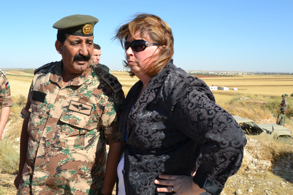 Crystal Canney, then an aide to Sen. Angus King, and a Jordanian military leader talk during a 2013 congressional trip. It was in Jordan, Canney says, that she began to realize the scope of the humanitarian crisis caused by the civil war in Syria.