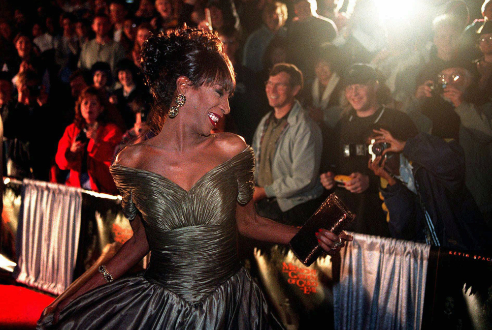 The Lady Chablis twirls for the crowd at the November 1997 premier of the movie "Midnight in the Garden of Good and Evil" in Savannah, Ga. Chablis died Thursday at age 59.