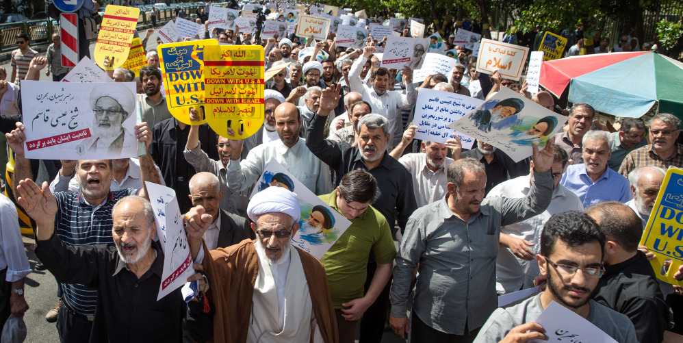 Iranian protesters chant slogans against the ruling Al Saud family of Saudi Arabia, America, Britain and Israel during a rally after weekly Friday prayers in Tehran.
