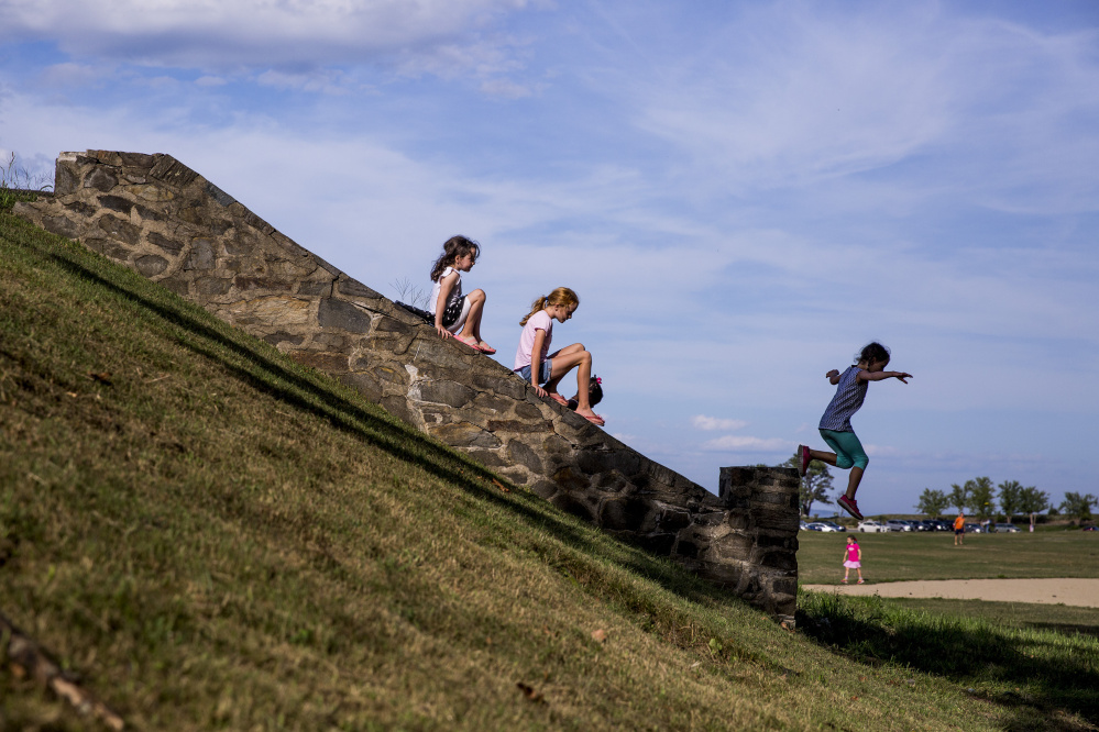 From left, Shyla McVeigh, 7, Hadley Mahoney, 10, and Alexandra Leopold, 7, all of Cape Elizabeth, play at Fort Williams Park in Cape Elizabeth, where 1.5 acres have been transformed into a natural wonderland for children.