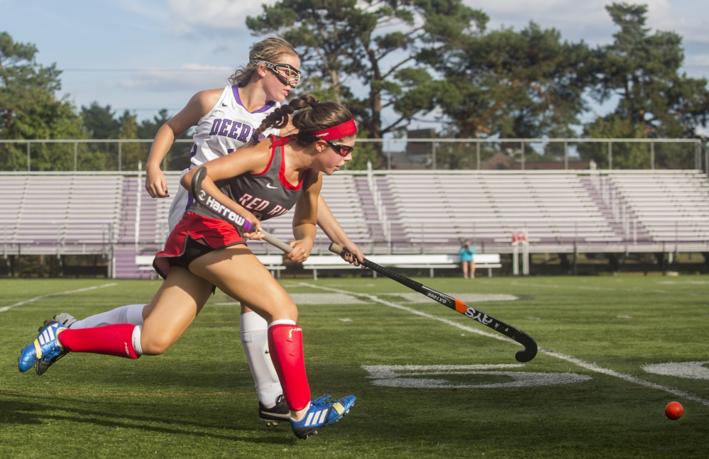 Amelia Papi, who finished with a goal and an assist for South Portland, races for the field hockey ball with Mackenzie O'Donnell of Deering during South Portland's 5-0 victory Friday at Deering High.