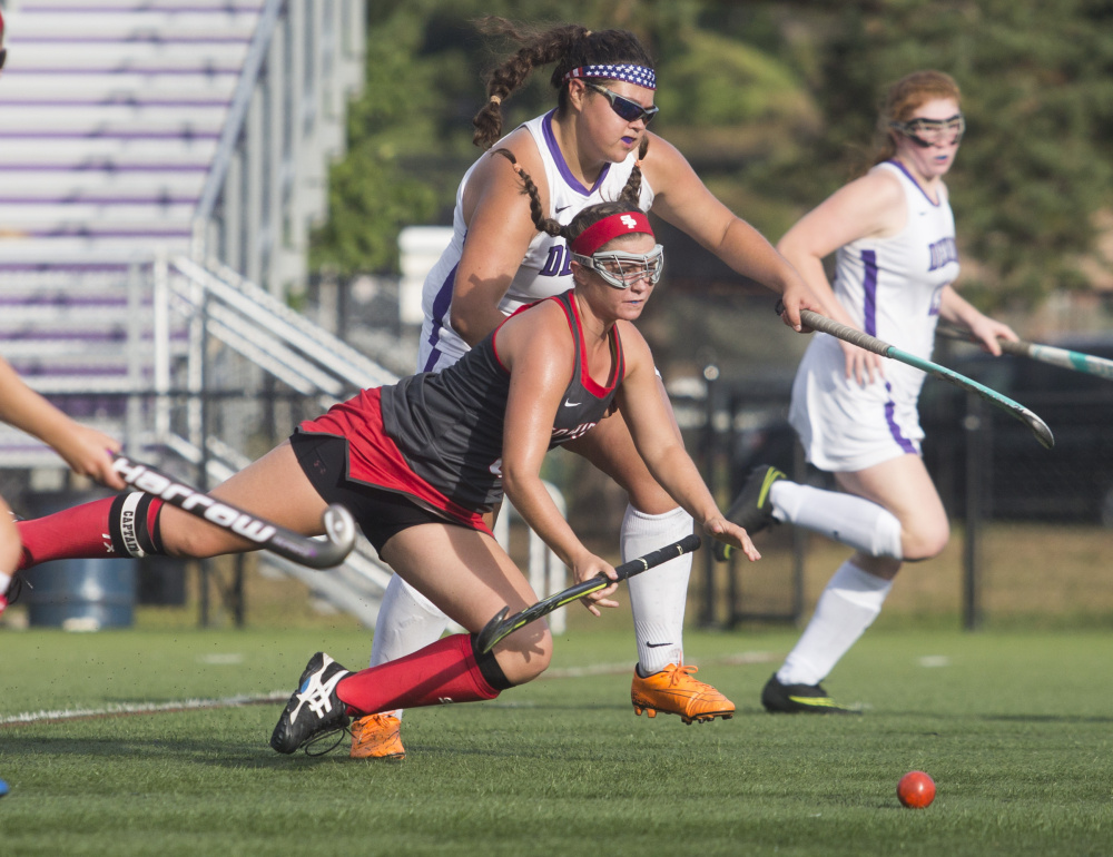 Lydia Henderson of South Portland heads to the ground while going for the ball against Deering. Henderson finished with a goal and an assist as the Red Riots won the first time this season. The Rams are 0-4.