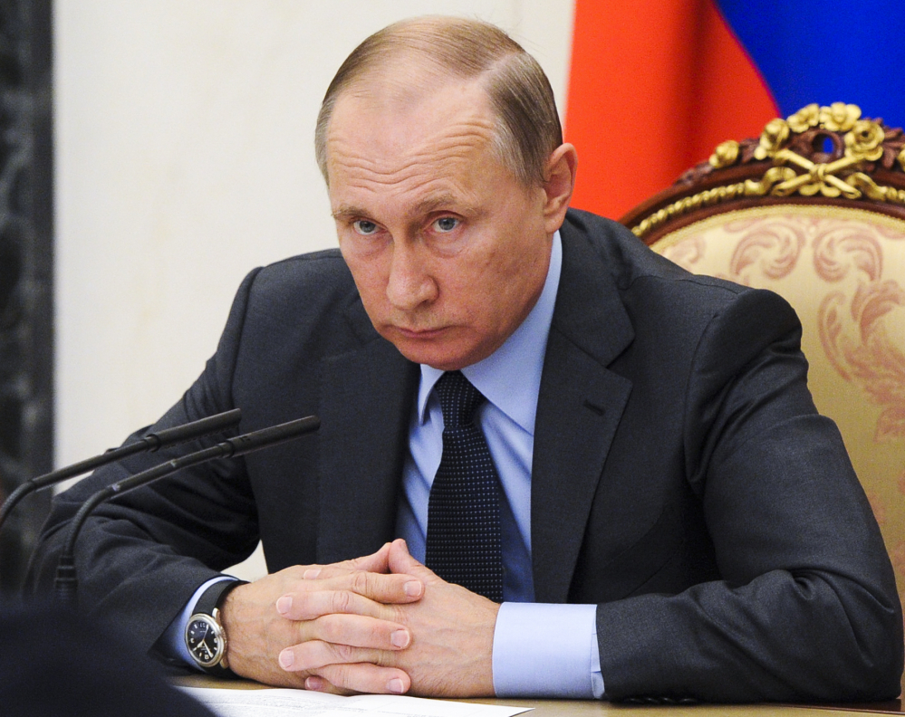 Russian President Vladimir Putin holds a Cabinet meeting Wednesday in Moscow's Kremlin. Recent hacks of election data systems in at least two states have raised fear among lawmakers and intelligence officials that a foreign government is trying to manipulate the presidential race, renewing debate over when cyberattacks warrant a U.S. response.