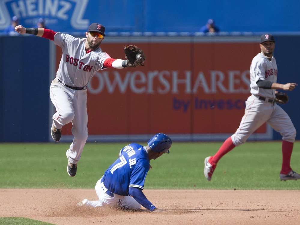 Toronto's Melvin Upton Jr. successfully steals second base beneath Boston second baseman Dustin Pedroia, left, during fourth inning in Toronto on Saturday. The Blue Jays won, 3-2.