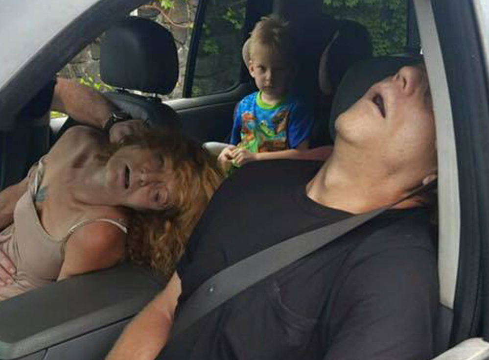 A boy witnesses a woman unconscious and turning blue alongside another overdosing adult in a car in East Liverpool, Ohio, on Wednesday. The city's director of public service and safety called the photo "the truth" about the addiction crisis.