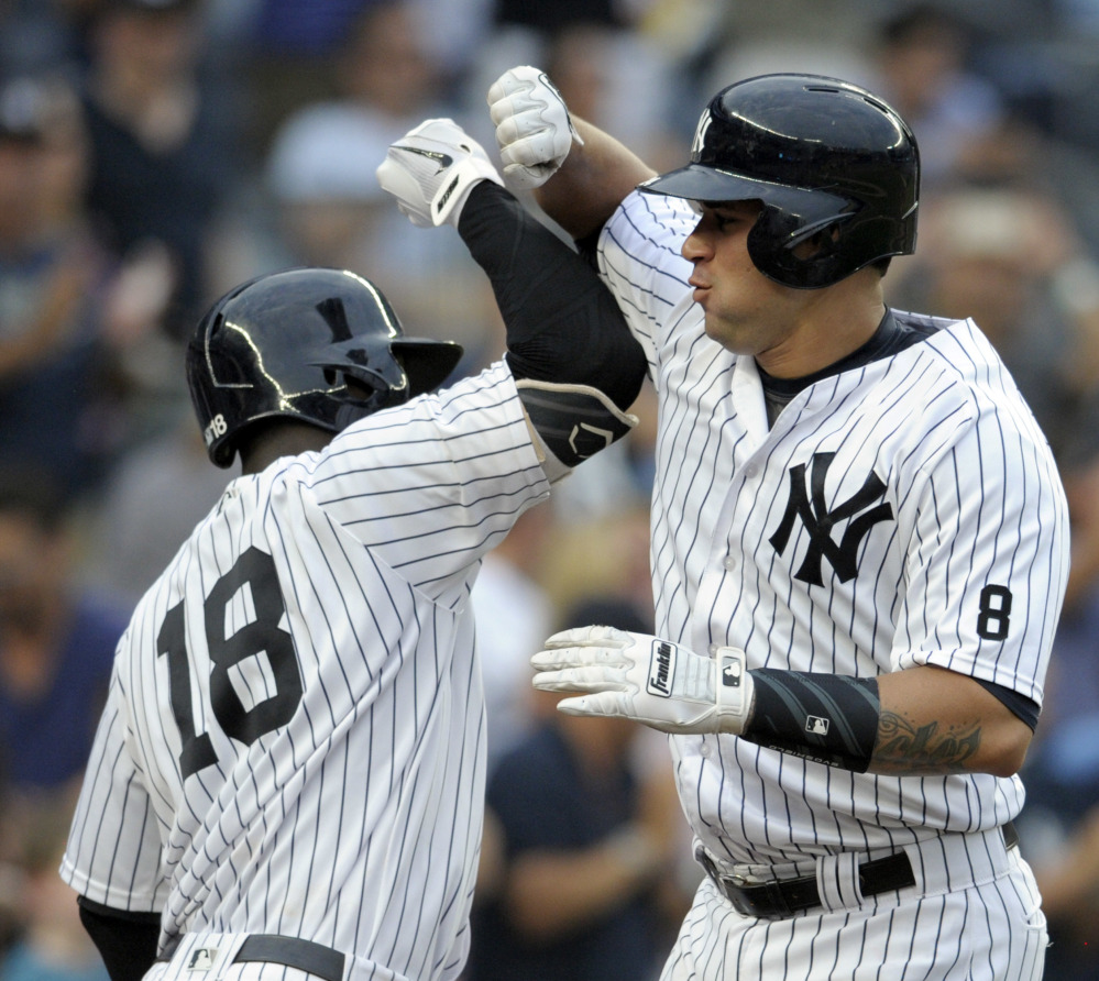 Gary Sanchez, right, celebrates with Didi Gregorius after hitting a home run in the sixth inning of the Yankees' 5-1 victory Saturday against Tampa Bay.