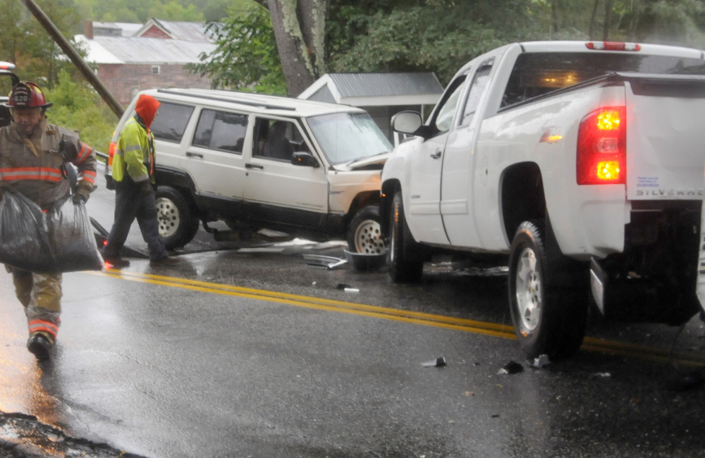 Responders investigate the cause of an accident Sunday morning on Litchfield's Hallowell Road that sent four people to the hospital with non-life-threatening injuries.