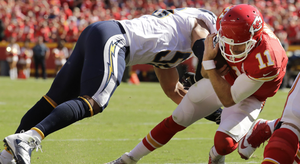 Chiefs quarterback Alex Smith dives past Chargers linebacker Tourek Williams to score the winning touchdown in overtime Sunday. The TD gave Kansas City a 33-27 victory.
