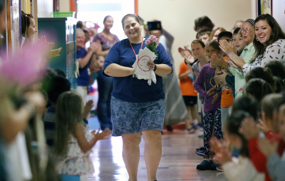 Laura Stevens, a teacher at James Otis Kaler Elementary School in South Portland, receives a school-wide welcome home Monday morning after receiving the Presidential Award for Excellence in Mathematics and Science Teaching from the National Science Foundation. She picked up the $10,000 award at a ceremony late last week in Washington, D.C.