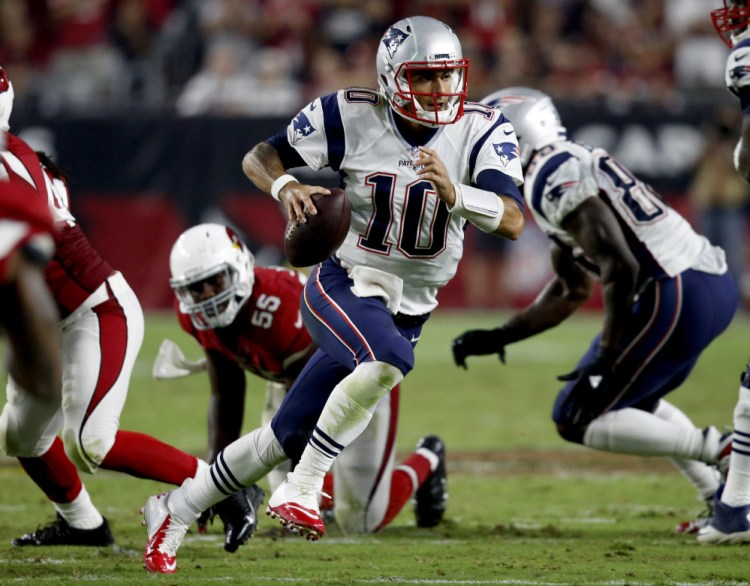 New England Patriots quarterback Jimmy Garoppolo scrambles against the Cardinals during the second half Sunday in Glendale, Ariz.