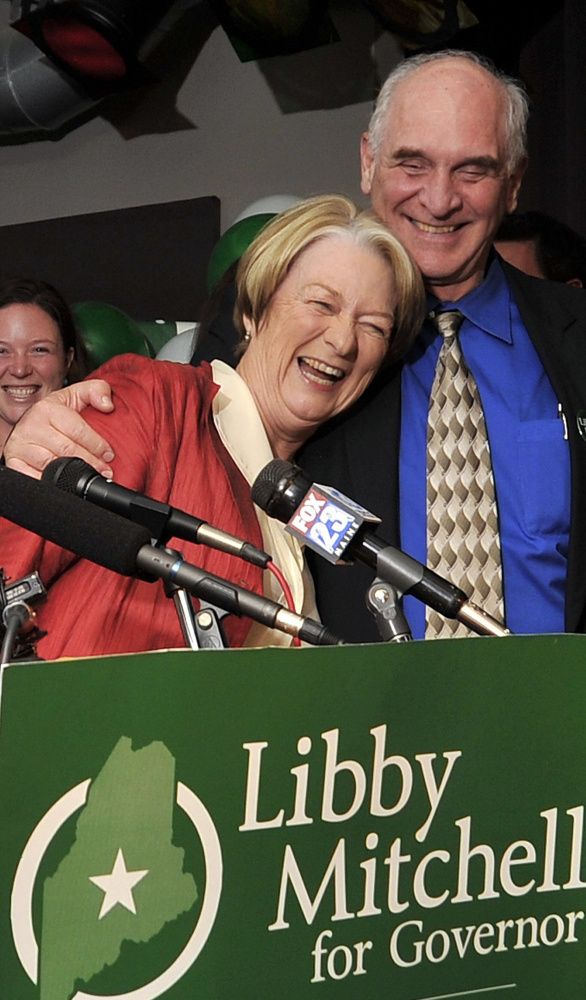 Libby Mitchell gets a hug from her husband, Jim, at her election night gathering in 2010 in Portland. Jim Mitchell was a judge of probate for 37 years in Kennebec County.
