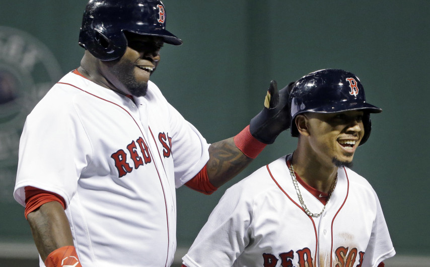 Red Sox's David Ortiz, left, celebrates with Mookie Betts after they scored on a single by Hanley Ramirez in the first inning against the Baltimore Orioles on Monday in Boston.