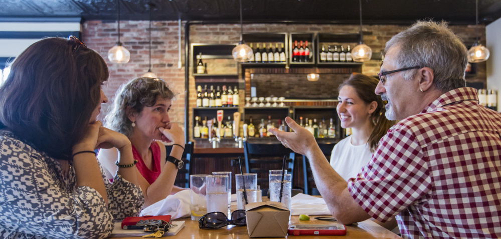 A group that is designing a food studies program for USM discusses plans over lunch at Isa Bistro on Portland Street. The effort is under the direction of Michael Hillard, right, and includes, from left, Mary-Elizabeth Simms, Jo D. Saffeir and Ali Mediate.