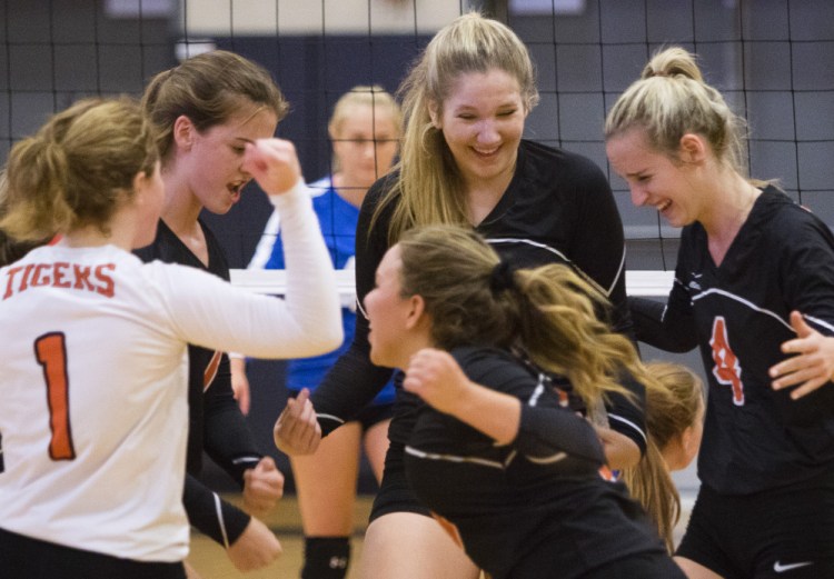 SEPT. 13: Biddeford players celebrate during their Class A volleyball match against Falmouth. The Tigers won in straight sets to improve to 3-1 and hand top-ranked Falmouth its first loss of the season.